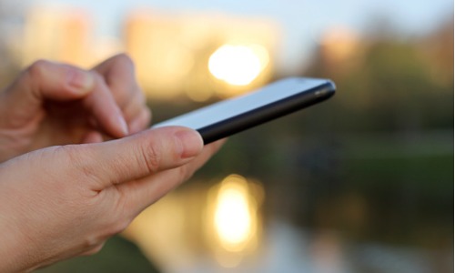 Hands with smartphone close up