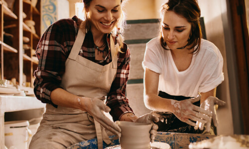 Two people making pottery