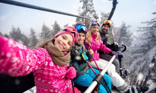 Happy family on ski lift