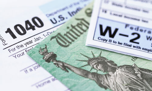 Income tax form, W-2 and treasury check.