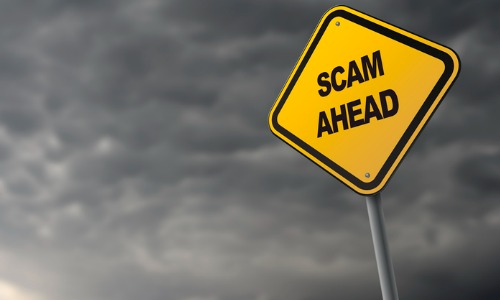 Road sign with words “scam ahead”