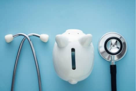 A stethoscope and a piggy bank